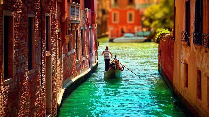 A Man Is Going With A Bot In Venice